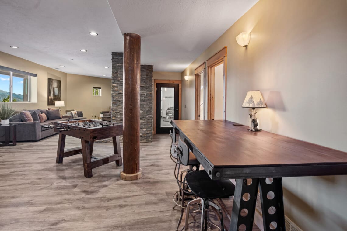 Den with foosball table and door to hot tub and gym